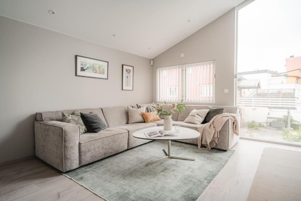 a living room with a couch and a table at ARCTIC HOMES - Unique Town House in Tromsø