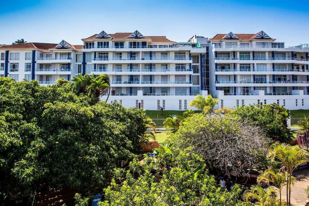 a large white building with trees in front of it at Seaside Getaway in Margate