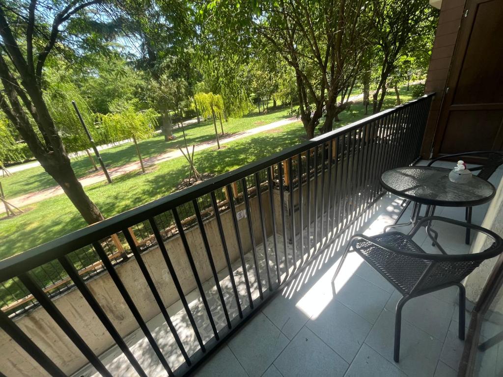 Un balcón con una mesa y una silla en el porche en Apartment-M14 in Kikvidze Park, en Tiflis