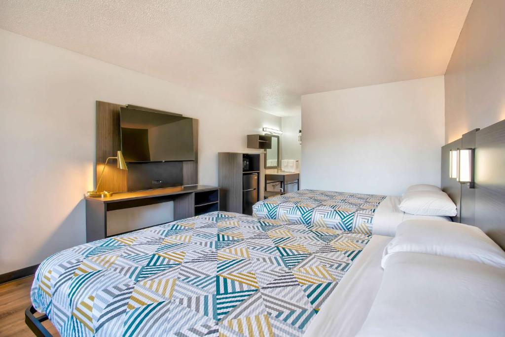 a hotel room with a bed and a flat screen tv at Motel 6-Bend, OR in Bend