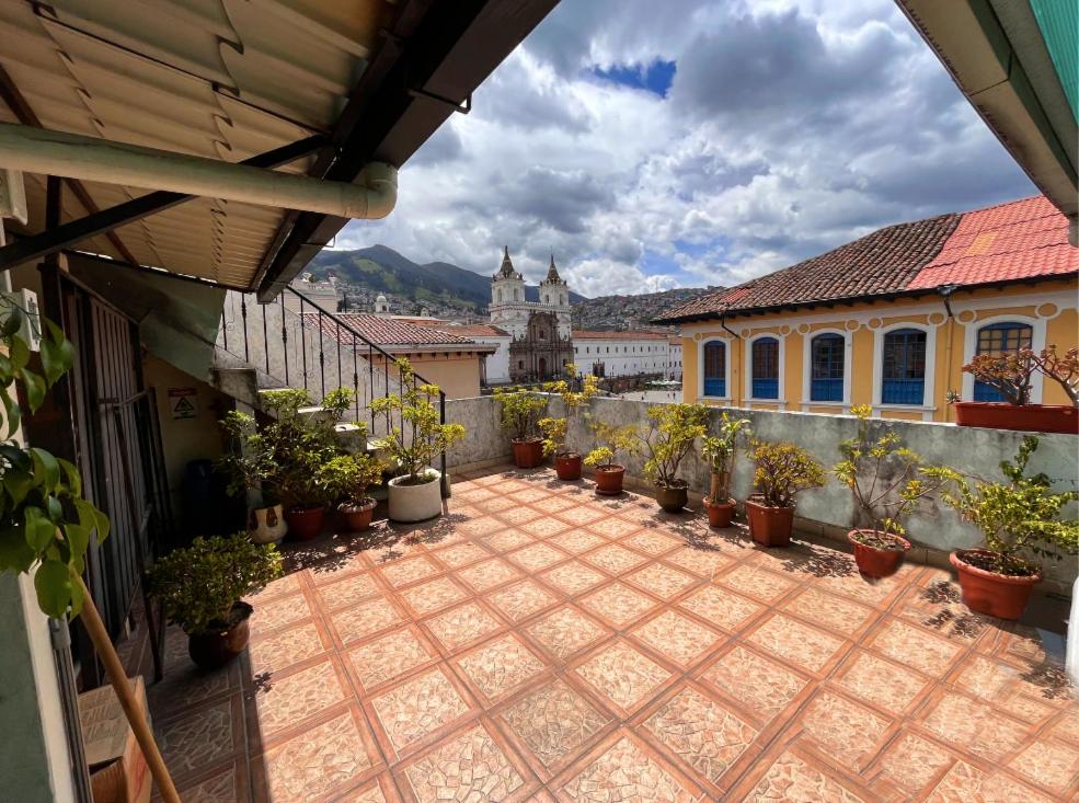 a courtyard with potted plants and a building at Hostal Benalcazar in Quito