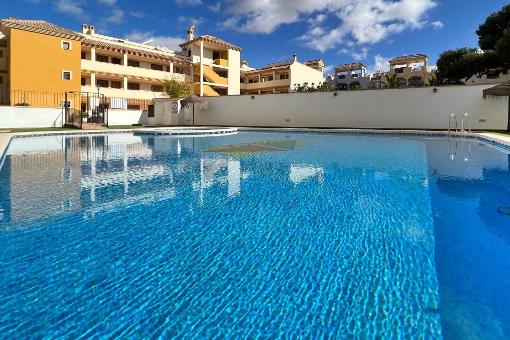 a swimming pool with blue water in a building at Roda, Sea and Golf in Roda