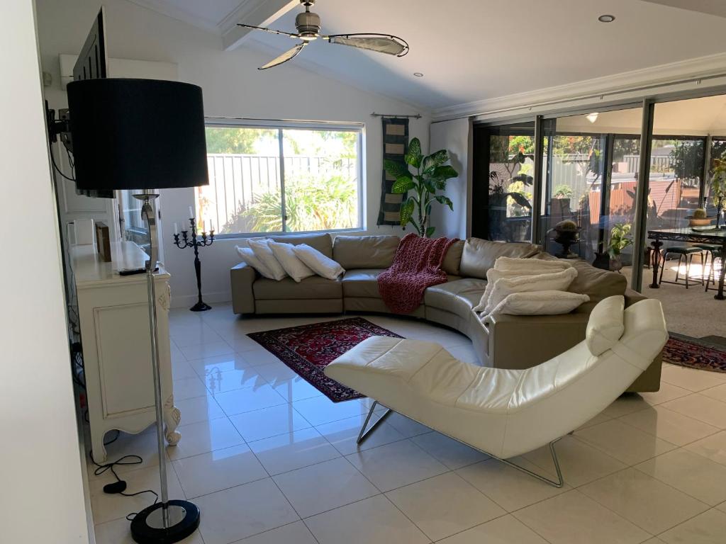 sala de estar con sofá y silla en Koombana Escape en Perth