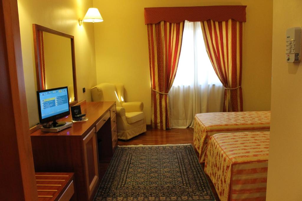 Łóżko lub łóżka w pokoju w obiekcie Hotel Grillo