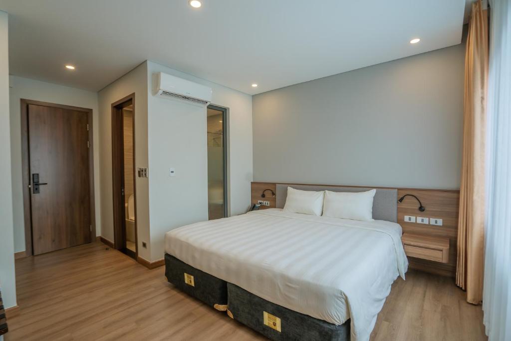 Кровать или кровати в номере Uông Bí Boutique Hotel