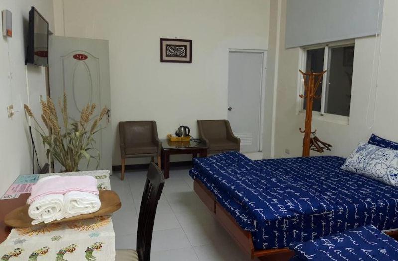 Postel nebo postele na pokoji v ubytování Hsianghua Guesthouse