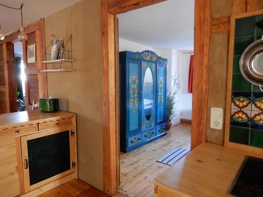 a kitchen with a blue cabinet in a room at Ländliches Wohnen zwischen Erfurt und Gotha in Erfurt