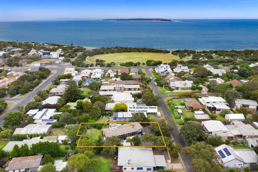 an aerial view of a town with houses and the ocean at Balclutha in Point Lonsdale