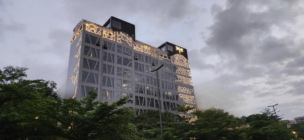 a tall building with writing on the side of it at Dragonfly Hotel- The Art Hotel in Mumbai