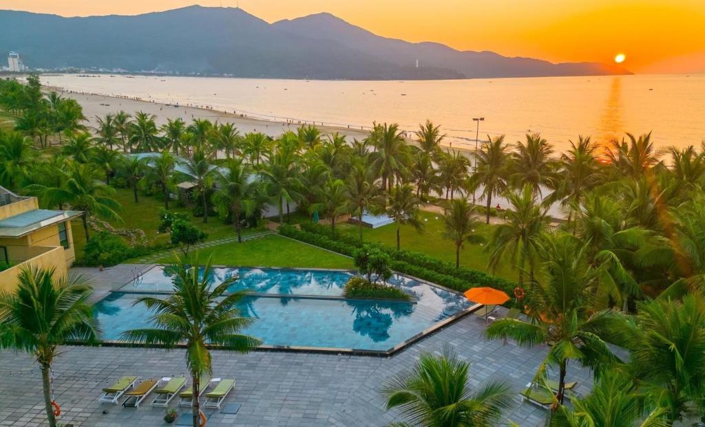 a view of a resort with a pool and a beach at Temple Da Nang Resort in Danang