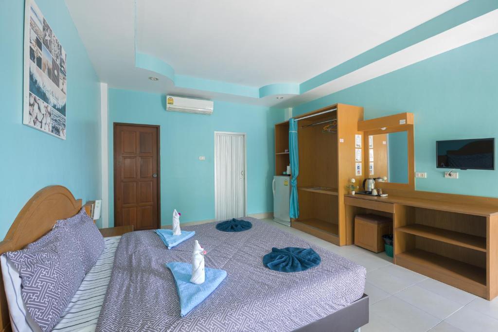 a bedroom with a bed with two towels on it at Grand View in Patong Beach