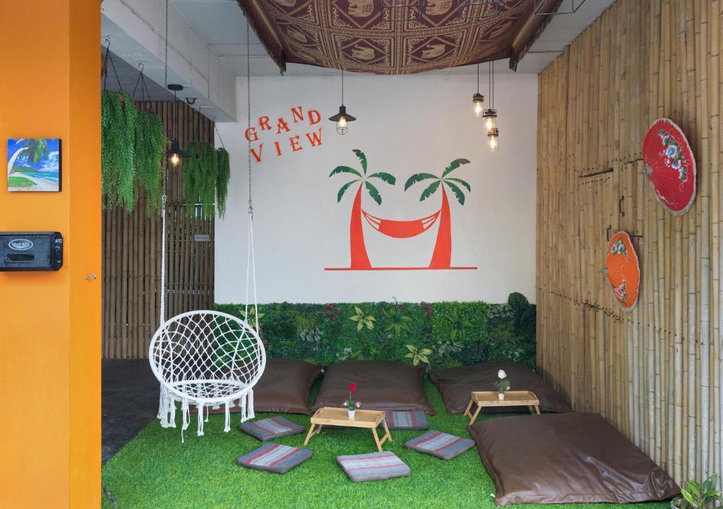 a room with a couch and chairs and a table at Grand View in Patong Beach