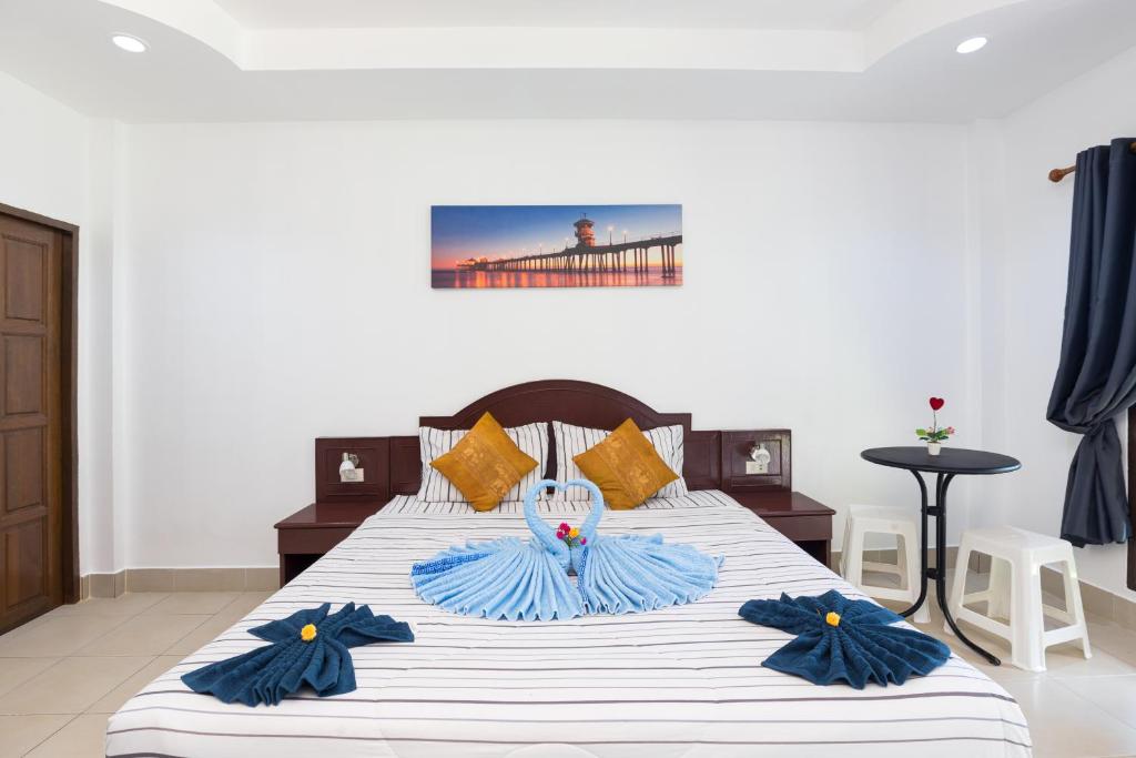 a bedroom with a large bed with blue and white sheets at Grand View in Patong Beach