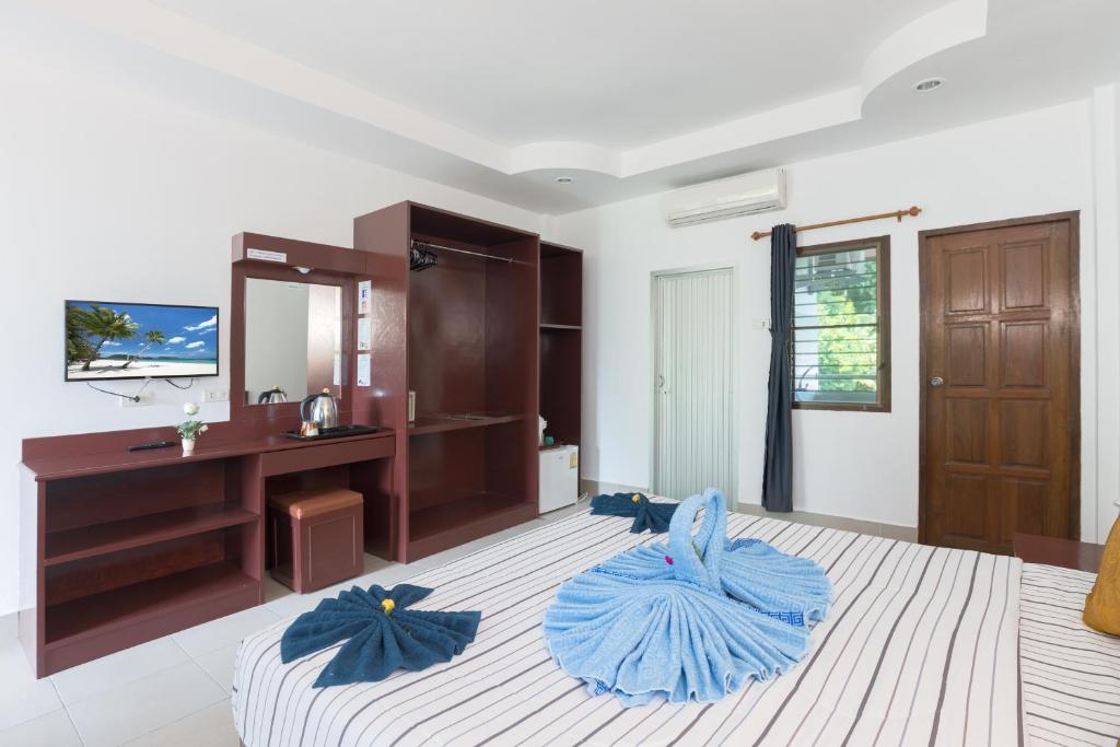 a bedroom with a bed with blue pillows on it at Grand View in Patong Beach