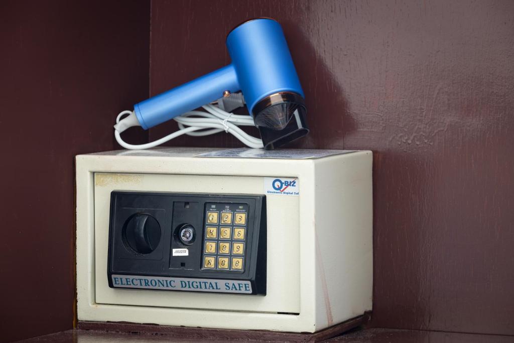 a blue pen sitting on top of a microwave oven at Grand View in Patong Beach