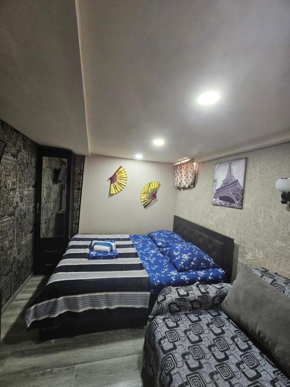 a bedroom with a bed and posters on the wall at Beqa house in Tbilisi City