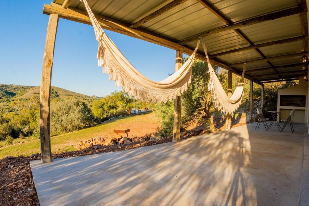 a porch with hammocks and a view of a field at Chacra Roxy in El Eden