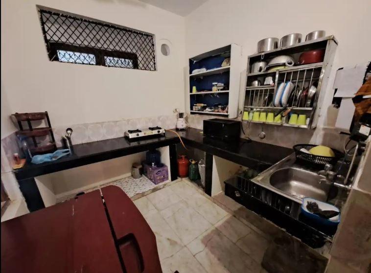 a kitchen with a sink and a counter top at Jasmine Stay by Walias in Gurgaon