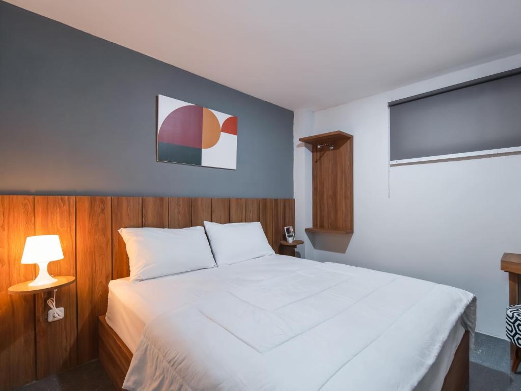 Tempat tidur dalam kamar di Cove Accordia Residence