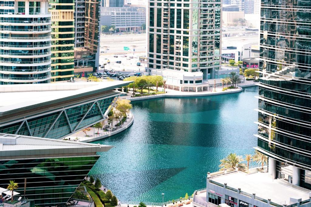 a river in the middle of a city with tall buildings at Songs of the Lake by Lagom - Bonnington Apartment Jumeirah Lake Towers, in Dubai