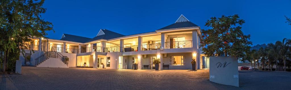 a large white building at night with its lights on at Monte Vidéo Guesthouse in Wellington