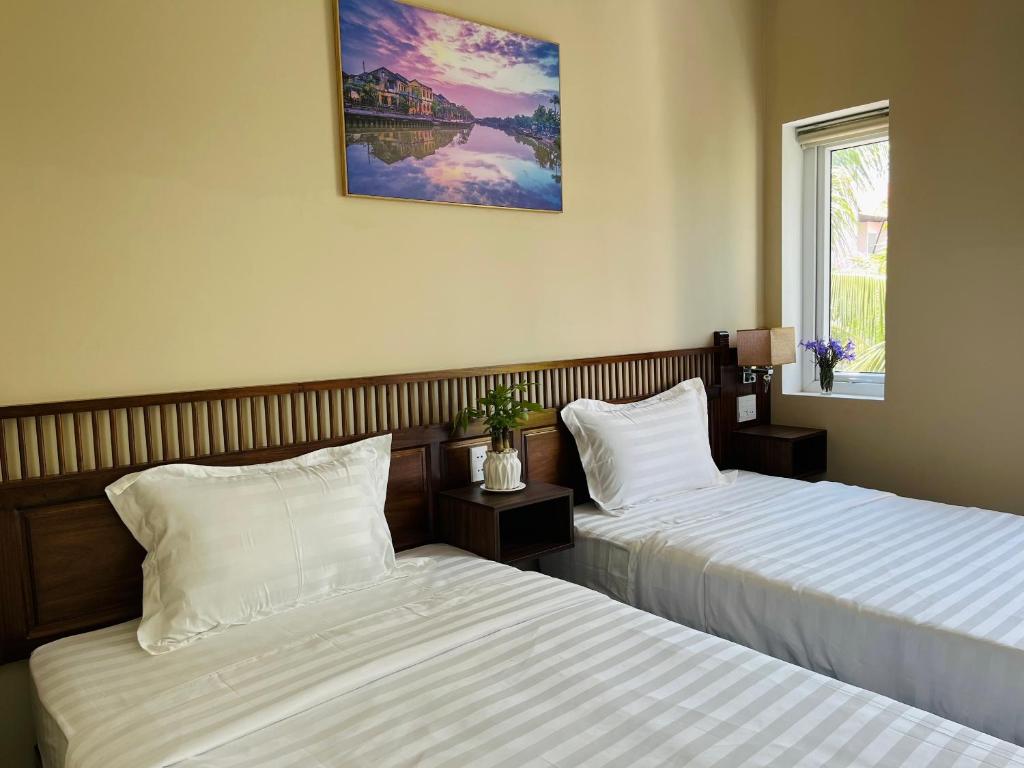 Postel nebo postele na pokoji v ubytování Kemi House Hoi An