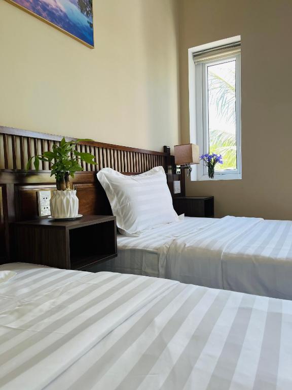 Postel nebo postele na pokoji v ubytování Kemi House Hoi An