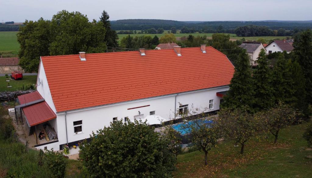 an aerial view of a white house with an orange roof at Farkas castle 