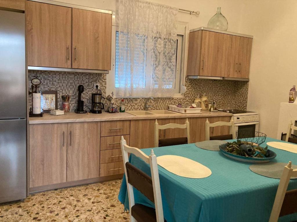 a kitchen with a table with a blue table cloth at TheTownSquareApartment in MalesÃ­na
