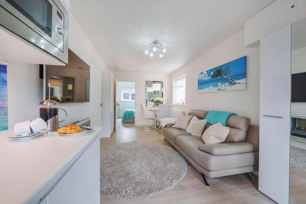 a living room with a couch and a table at The Sanctuary in Exmouth