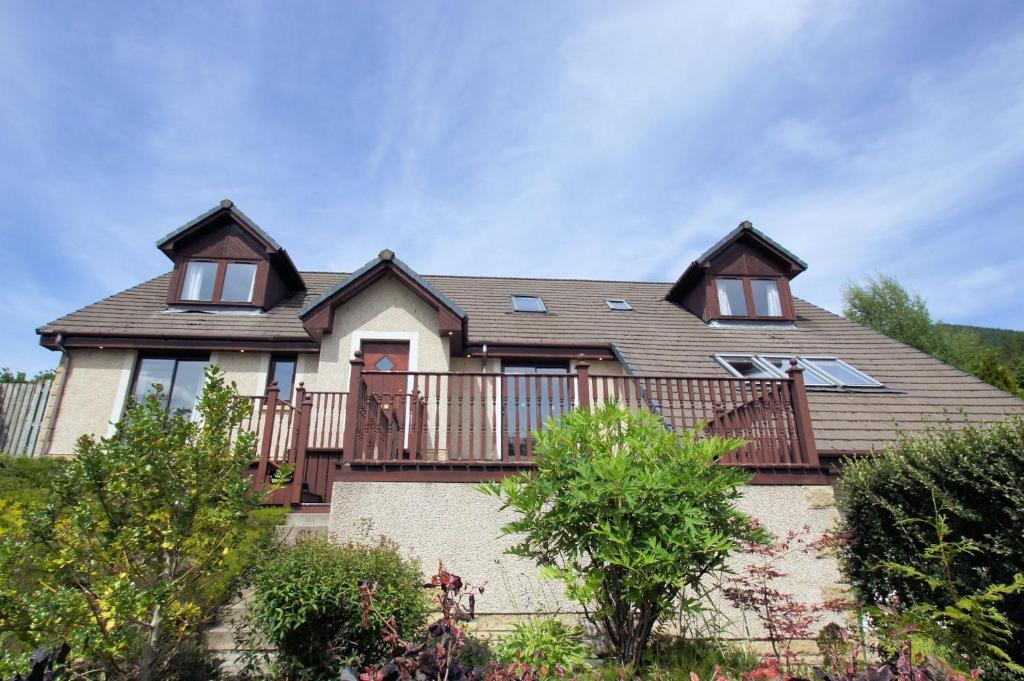 a large house with a large deck on top at Osprey View in Lochearnhead