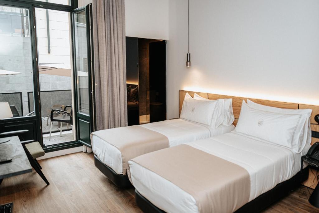 Postel nebo postele na pokoji v ubytování Hotel Luruna Palacio Larrinaga