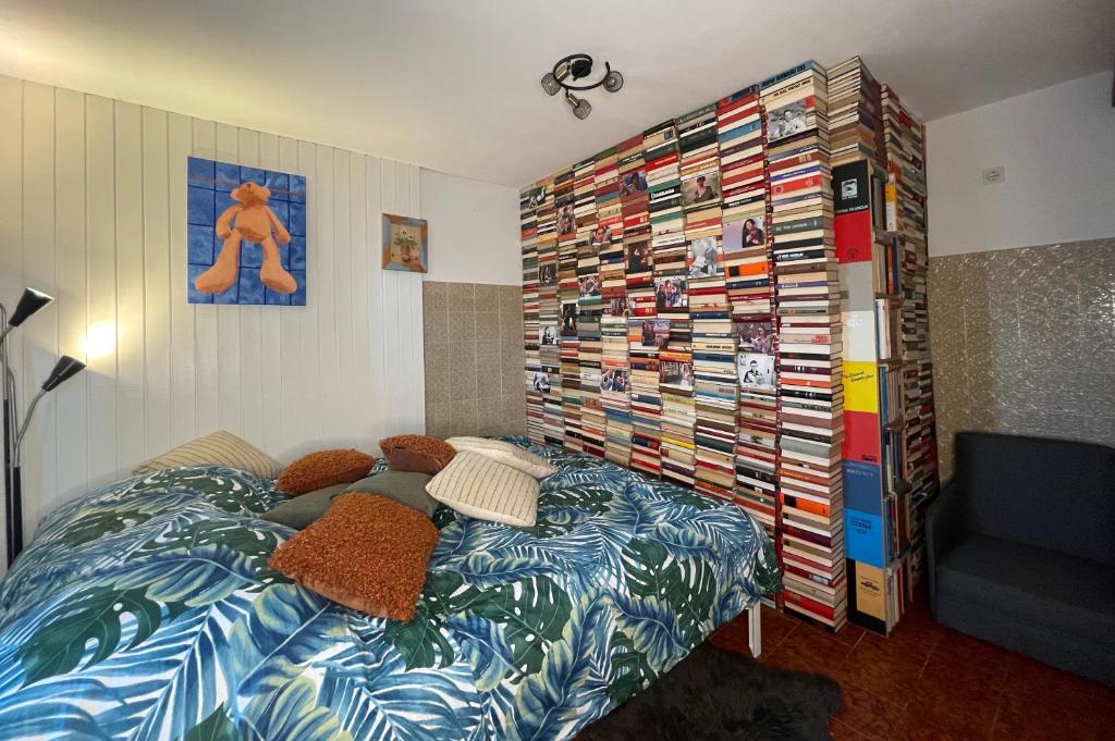 a bedroom with a bed and a wall of cds at Book house 