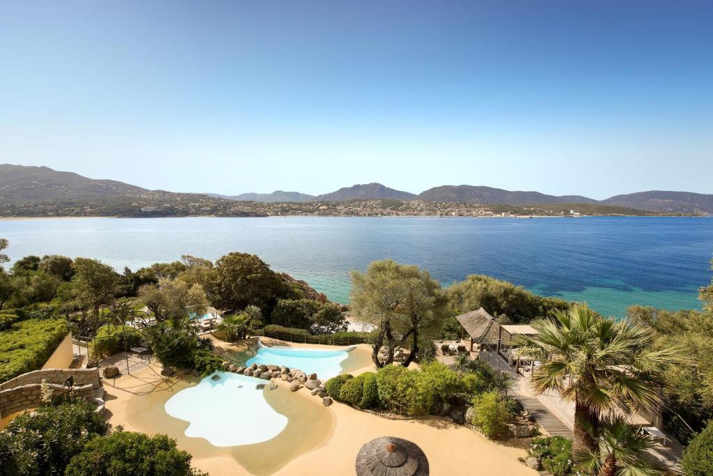 an aerial view of the resort and the water at Hôtel Marinca & Spa in Olmeto