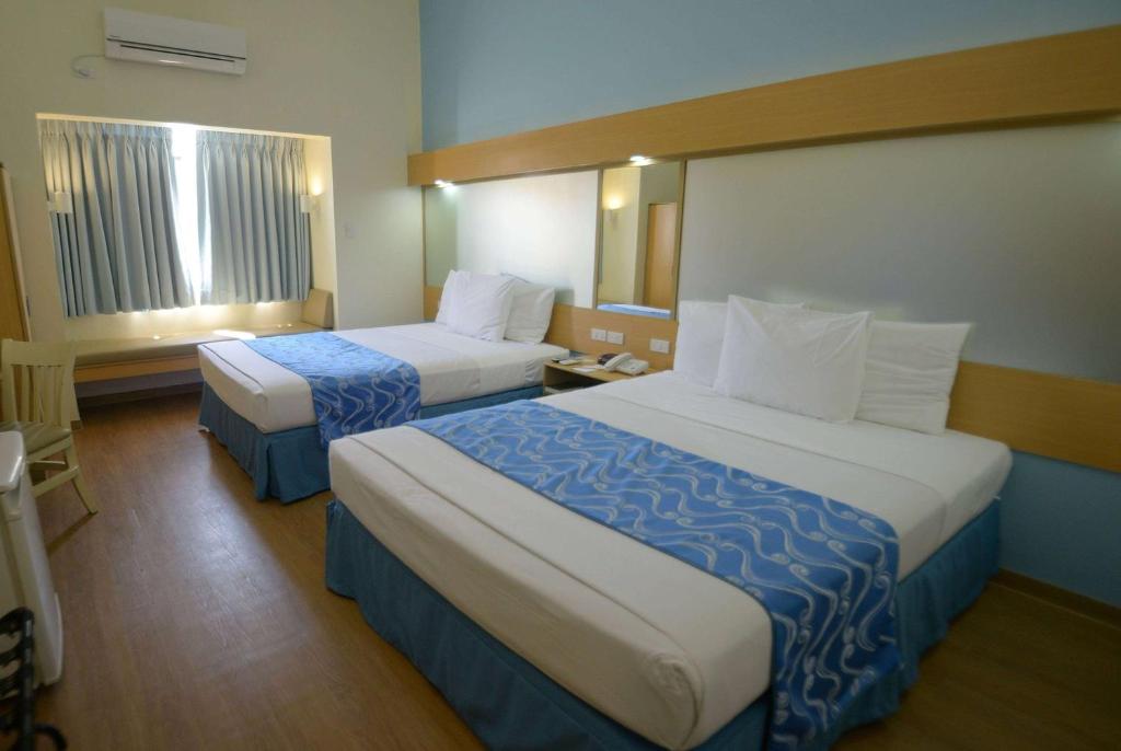 Postel nebo postele na pokoji v ubytování Microtel by Wyndham Davao