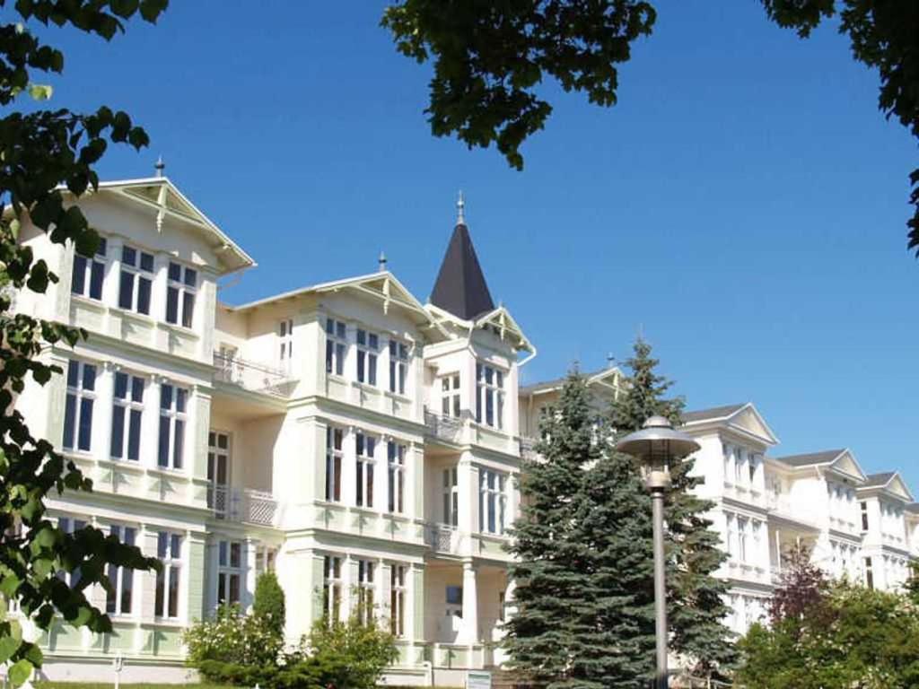 a large white building with trees in front of it at Dünenstraße 25 in Zinnowitz