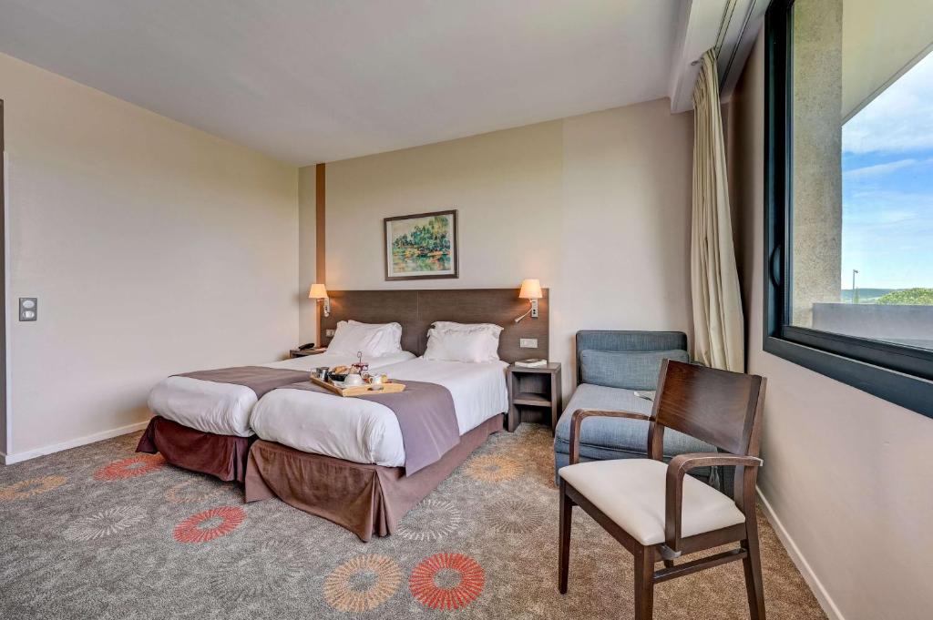 Postel nebo postele na pokoji v ubytování Best Western Sévan Parc Hôtel