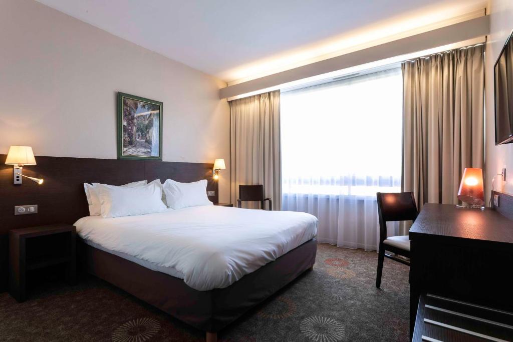 Postel nebo postele na pokoji v ubytování Best Western Sévan Parc Hôtel