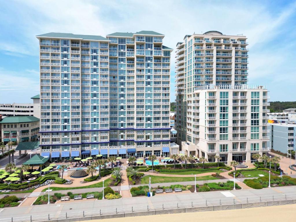 two tall buildings in a city next to a beach at Hilton Vacation Club Oceanaire Virginia Beach in Virginia Beach