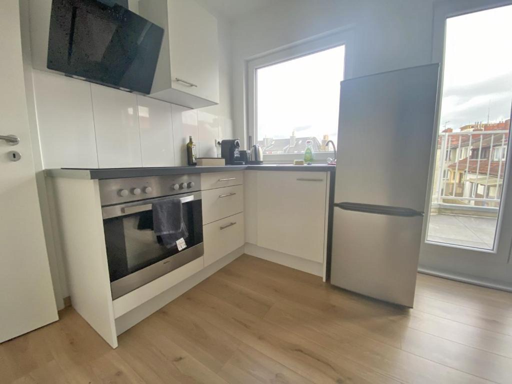 a kitchen with a stove and a sink and a refrigerator at Air Apartments 2 in Bremen