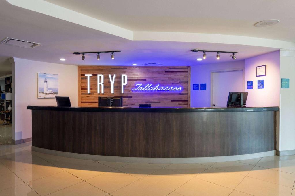 a hotel lobby with a complimentary complimentary reception desk at TRYP by Wyndham Tallahassee North I-10 Capital Circle in Tallahassee