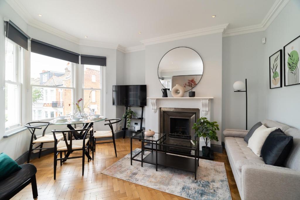 - un salon avec un canapé et une table dans l'établissement Margravine Gardens by Viridian Apartments, à Londres