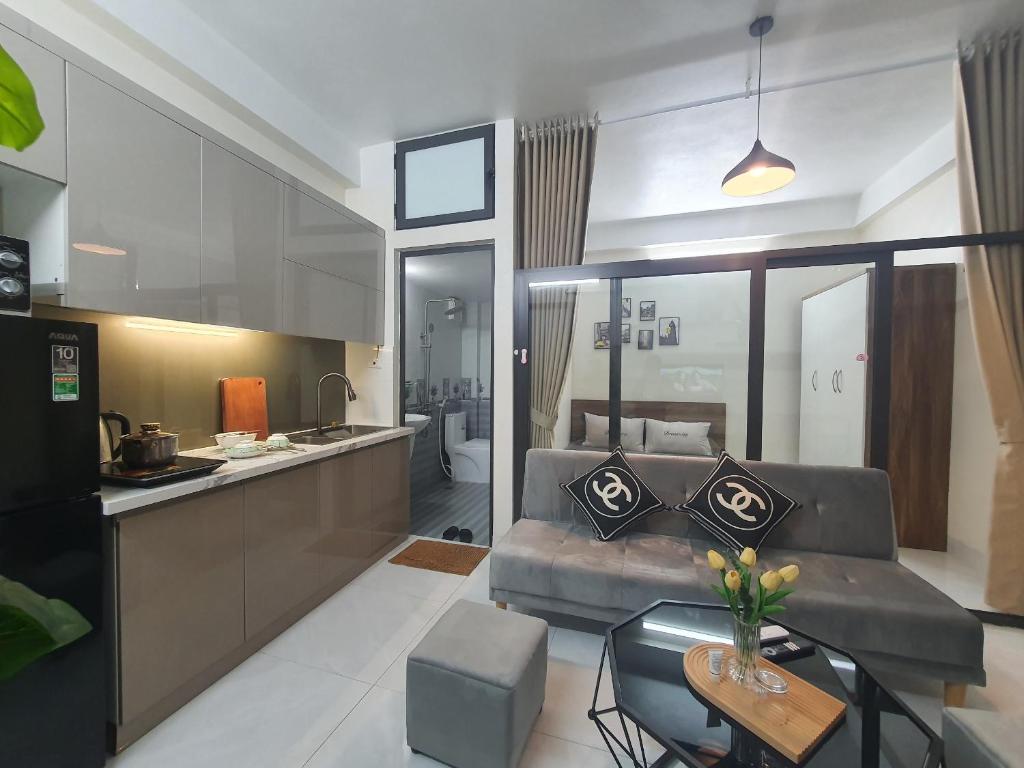 Apartment 59 Phạm Văn Đồng, Hà Nội في هانوي: مطبخ وغرفة معيشة مع أريكة وطاولة
