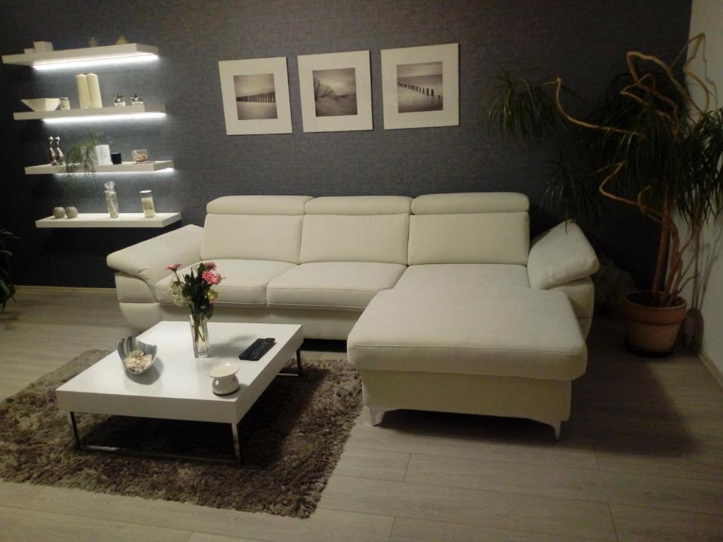 a living room with a white couch and a coffee table at Ubytování U Kapličky in Olomouc
