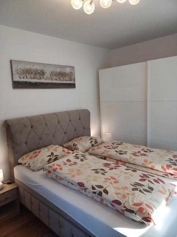 a bedroom with a bed with a bedspread on it at EDIK in Velika Gorica