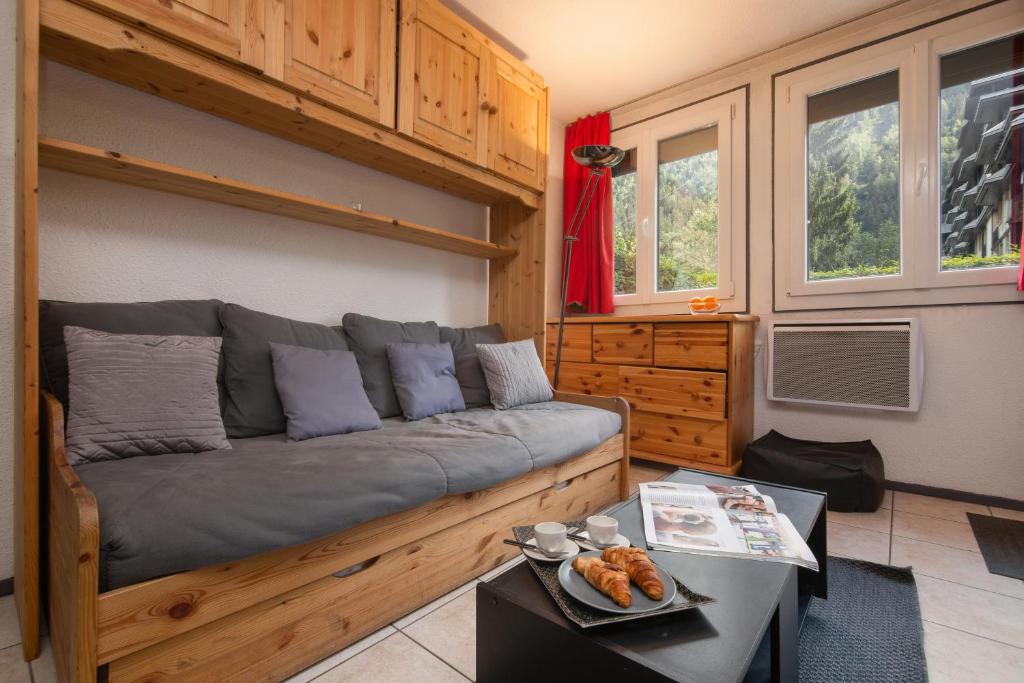 a living room with a couch and a coffee table at Chamonix Sud - Jonquilles 30 - Happy Rentals in Chamonix-Mont-Blanc