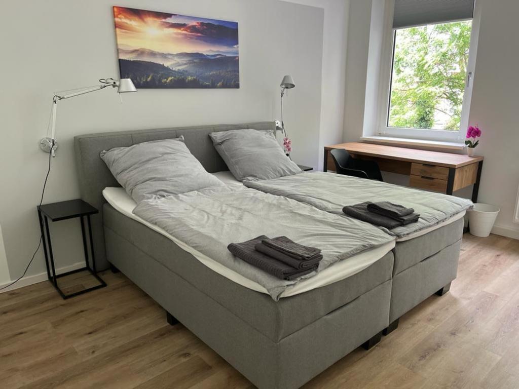 a large bed in a room with a window at Wohlfühl-Oase in Herne