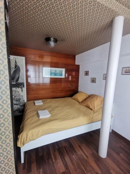 a bedroom with a large bed with a wooden ceiling at NEB-Thun Haus in Thun für 8 Pax in Thun