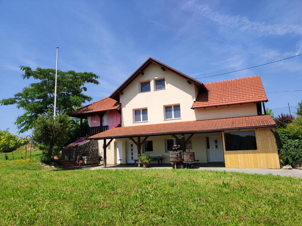 a white house with a red roof at KUĆA ZA ODMOR GRUNT in Pakrac