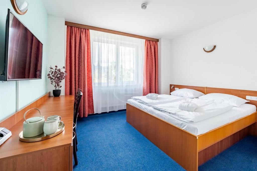 a bedroom with a bed and a large window at Apartmán C409 v areálu Wellness hotelu Frymburk in Frymburk